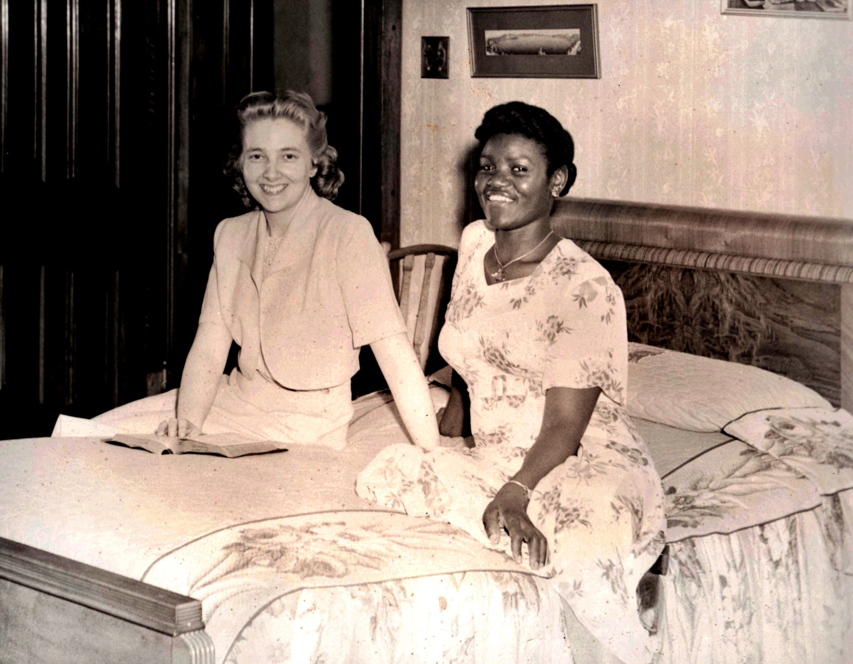 MOTHER DIVINE with Miss Peaceful Love, her companion -maid, taken at the Divine Lorraine Hotel durring the anniversarry of Her Marriage to FATHER DIVINE. The dress of followers is modest at all times and baring of shoulders is taboo.