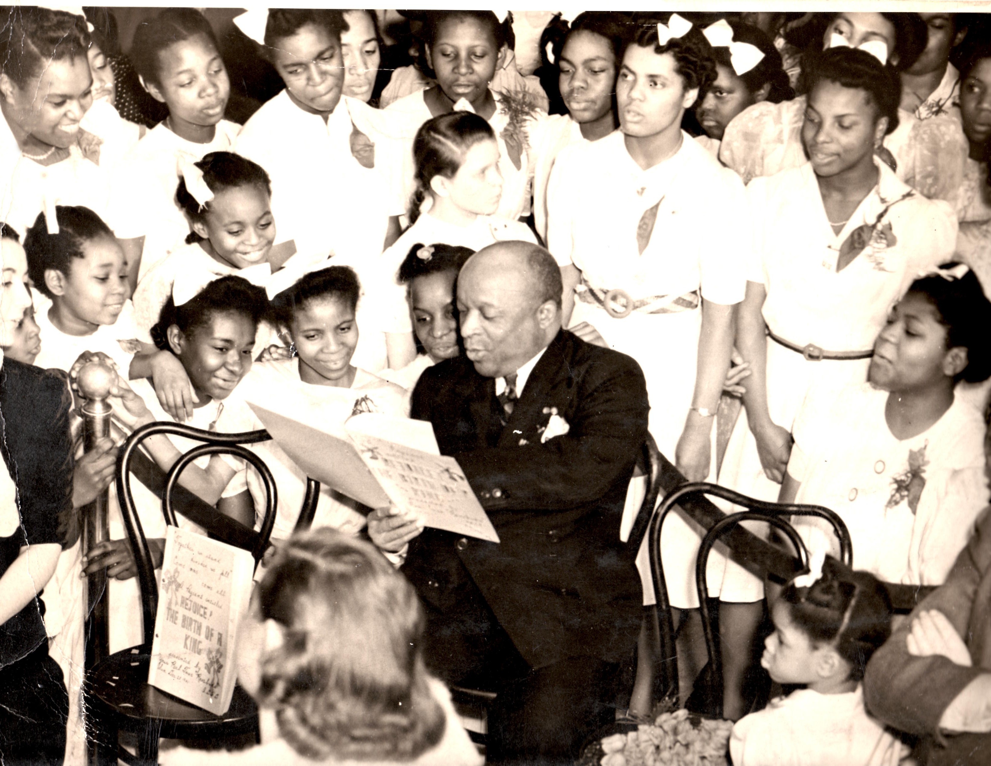 FATHER DIVINE with a group of junior Rosebuds