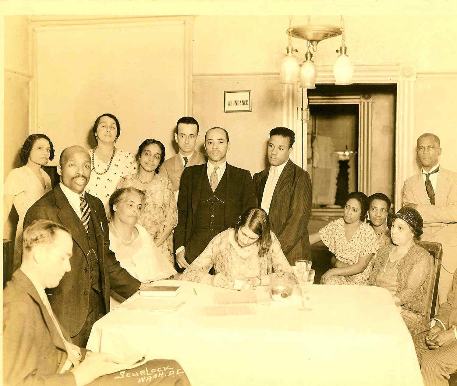 An early photo of FATHER DIVINE with a group