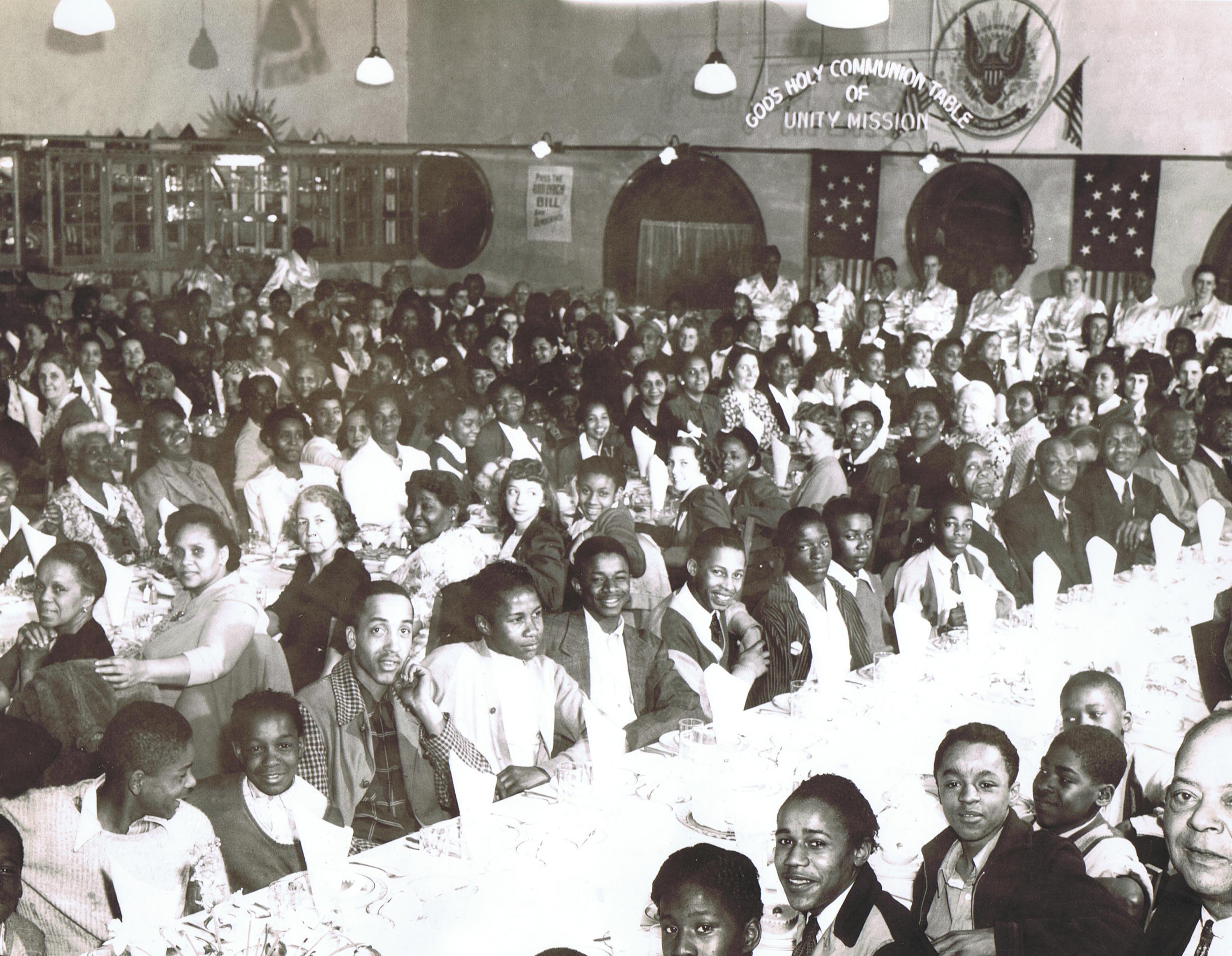 Neighborhood children being served at the Holy Communion Table of the Unity Mission Church,Philadelphia, PA.